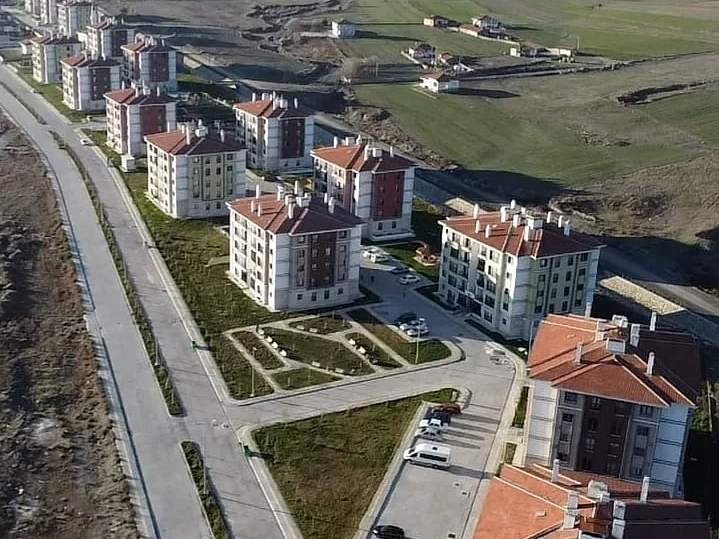 Turhal yerleşkesinin havadan görünümü: vadide yol boyunca sıralanan kiremit çatılı konut blokları